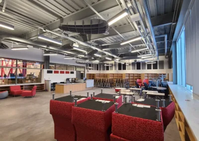 A room with red chairs and tables.